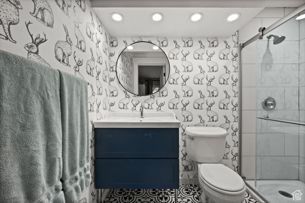Full bathroom with toilet, a shower stall, vanity, and recessed lighting