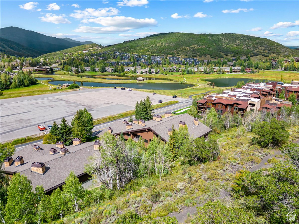 View of mountain background featuring a nearby body of water and nearby suburban area