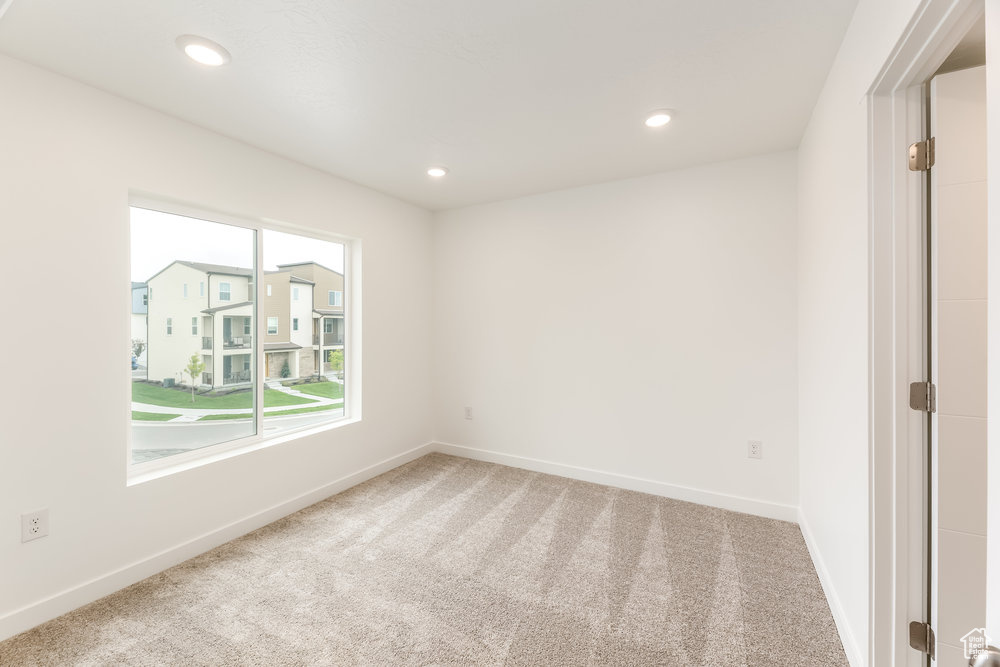 Unfurnished room featuring carpet flooring, baseboards, and recessed lighting