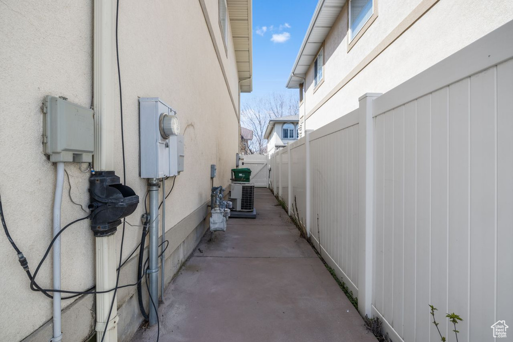 View of home\'s exterior with a patio, stucco siding, and fence