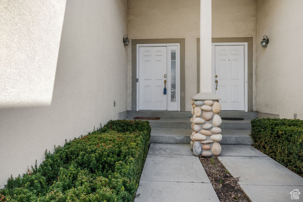 Doorway to property featuring stucco siding