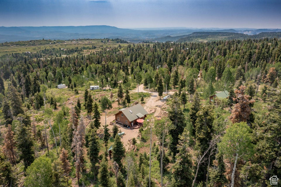 View of property location featuring a heavily wooded area and mountains