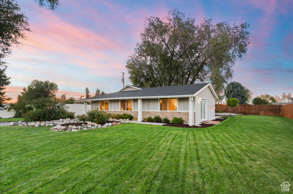 Single story home with stone siding and board and batten siding