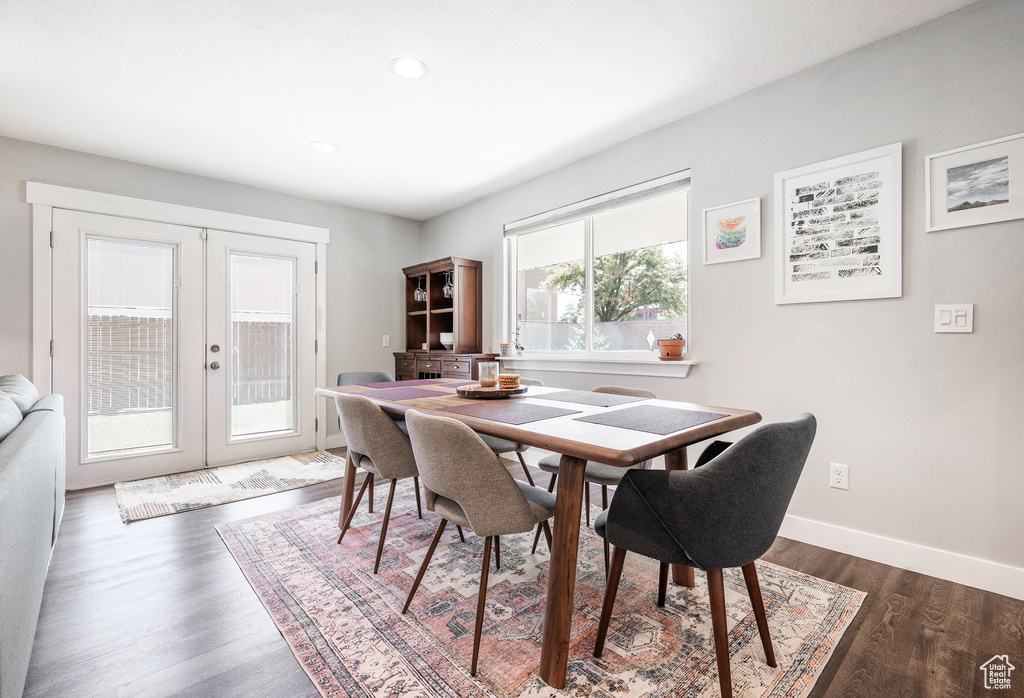 Dining area featuring french doors, dark wood-style floors, baseboards, and recessed lighting