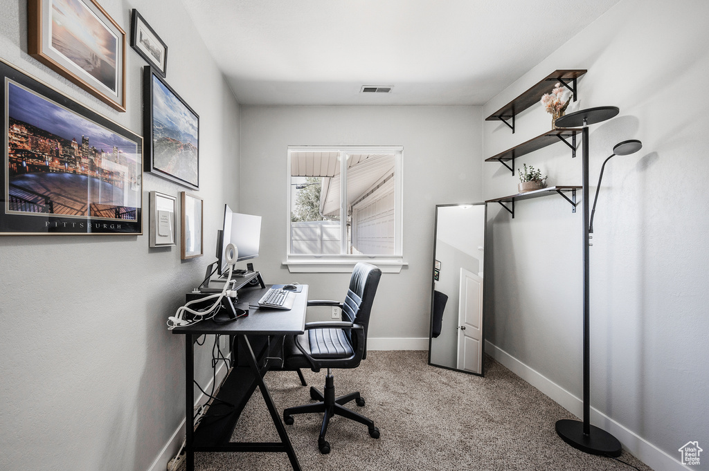 Carpeted home office with baseboards