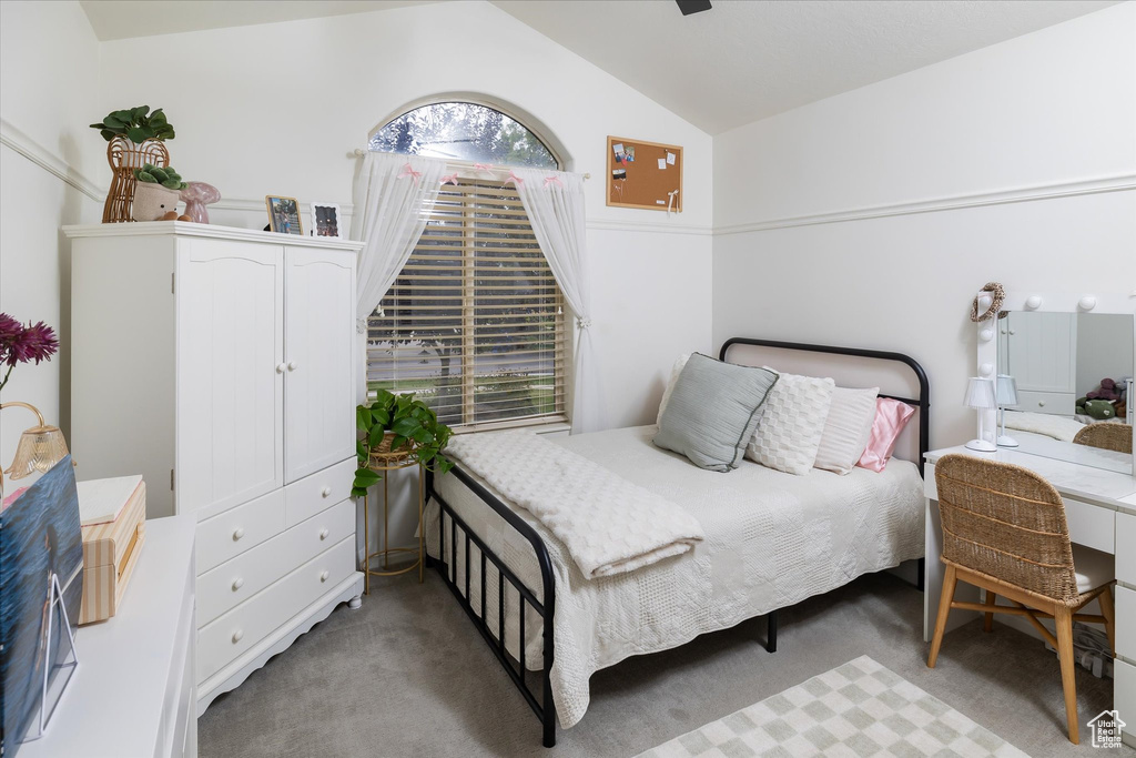 Bedroom with lofted ceiling and carpet floors