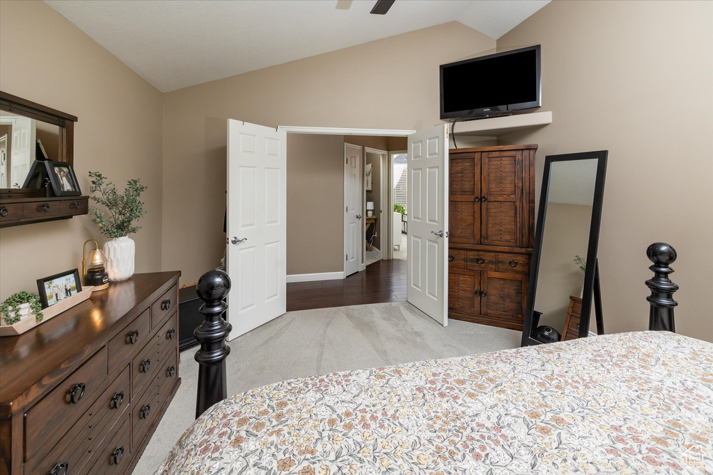 Carpeted bedroom featuring vaulted ceiling and baseboards