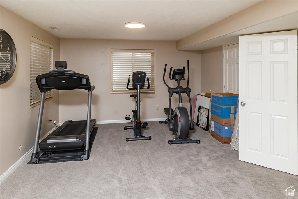 Workout room featuring baseboards and carpet flooring