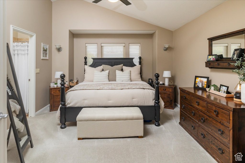 Bedroom with light colored carpet, vaulted ceiling, baseboards, and a ceiling fan