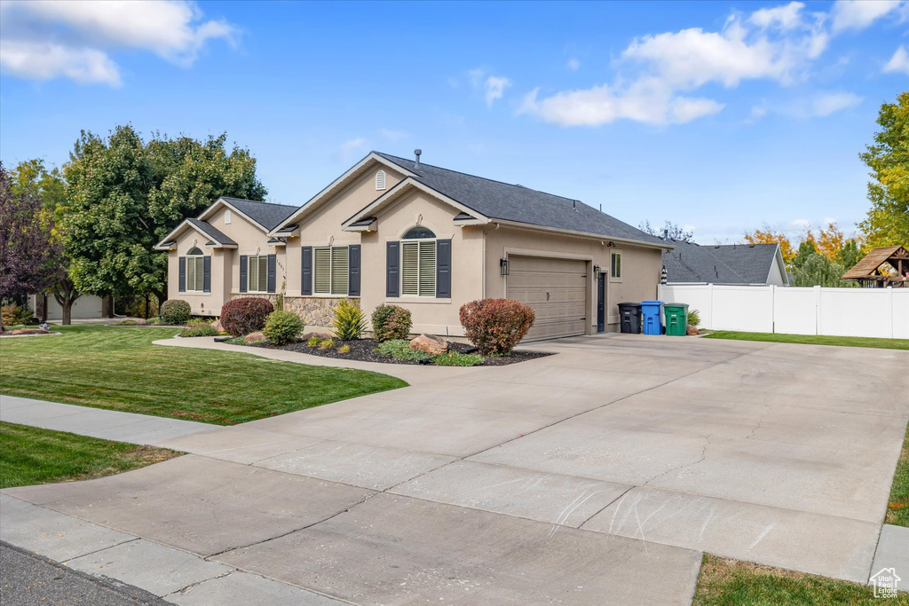 Single story home featuring stucco siding, concrete driveway, and an attached garage