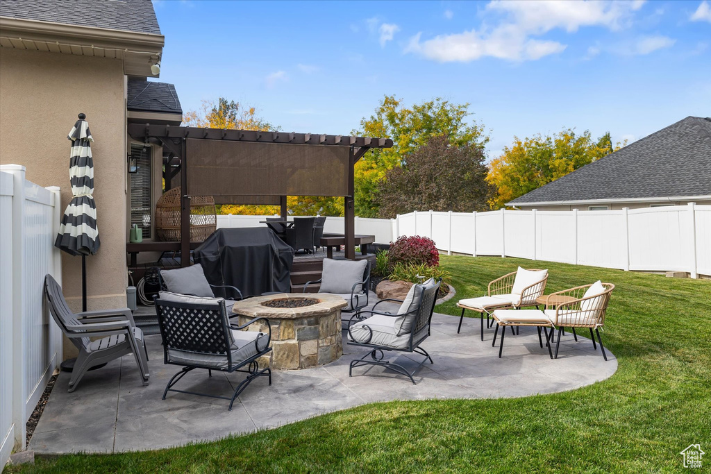 View of patio featuring an outdoor fire pit and grilling area