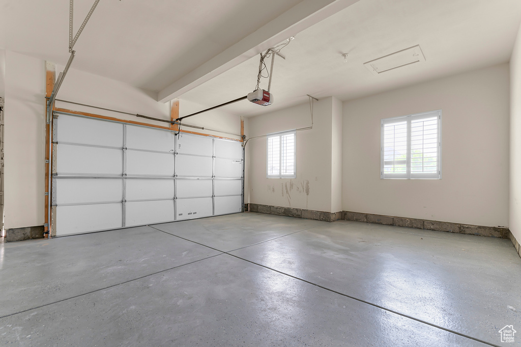 Garage featuring a garage door opener