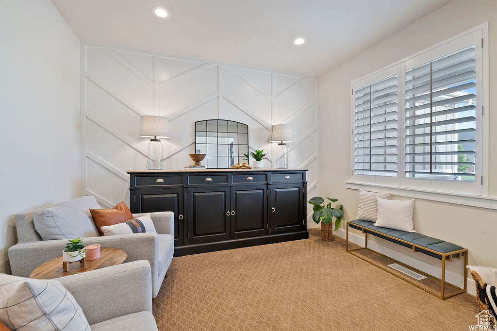 Sitting room with light carpet, recessed lighting, and baseboards