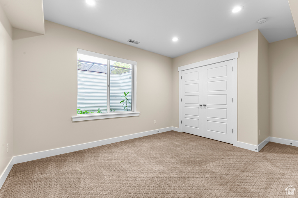 Unfurnished bedroom with recessed lighting, baseboards, carpet floors, and a closet