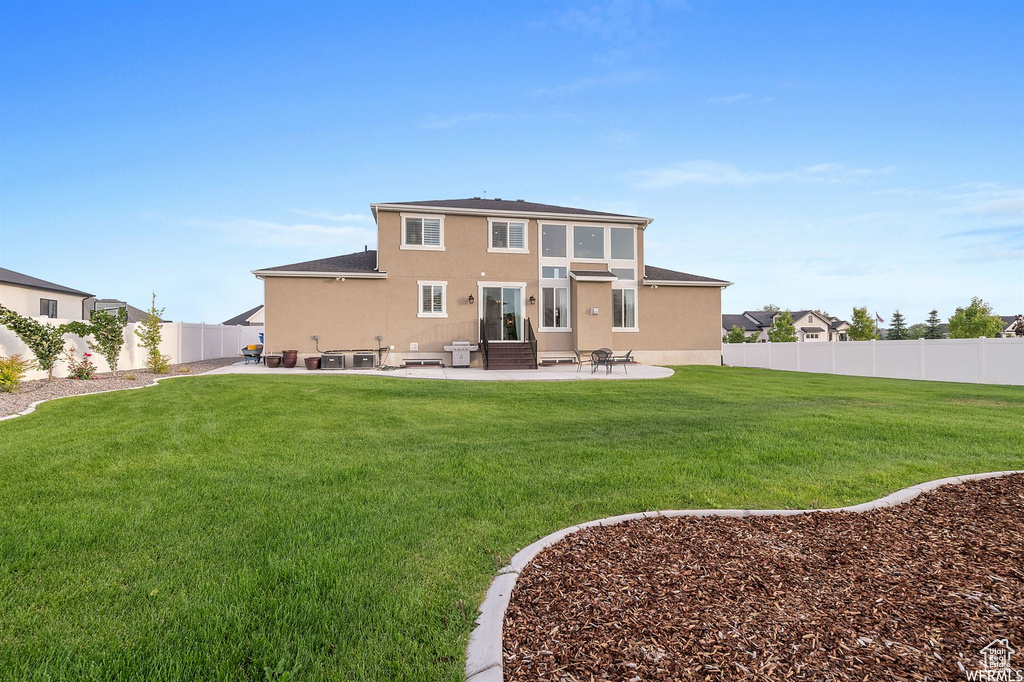 Back of house featuring a patio area, stucco siding, and entry steps