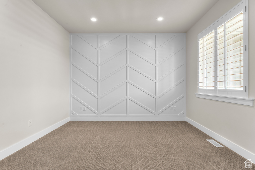 Spare room featuring baseboards, carpet, recessed lighting, and healthy amount of natural light