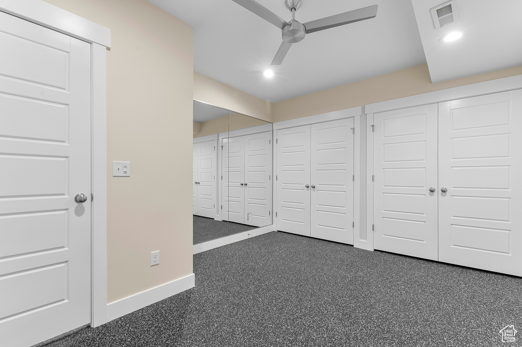 Unfurnished bedroom featuring baseboards, two closets, recessed lighting, and a ceiling fan