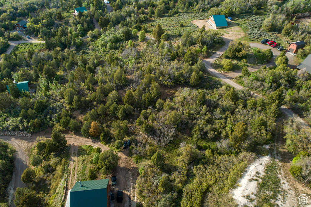 Aerial view of property and surrounding area featuring a forest