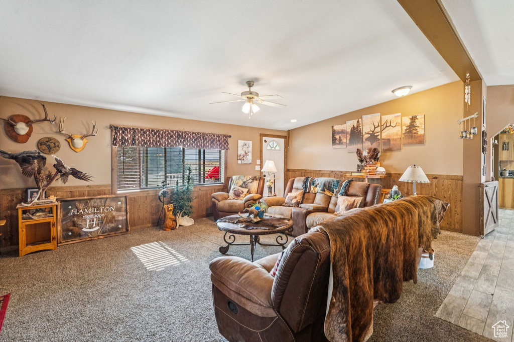 Living area with a ceiling fan and wainscoting