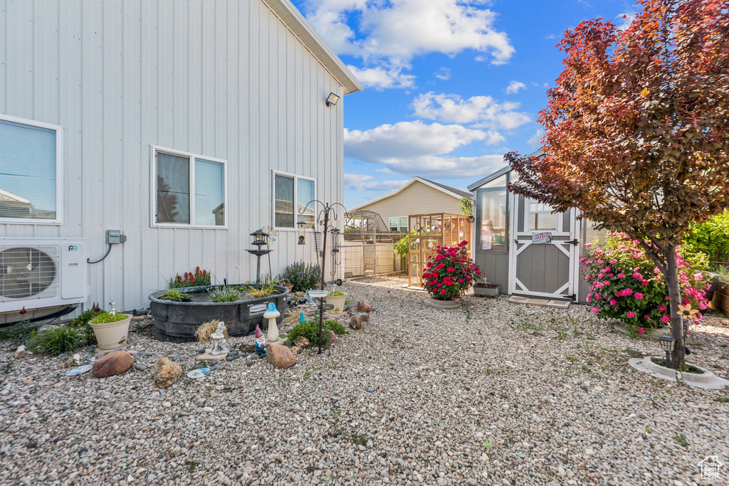 View of yard with a cooling unit and an outdoor structure