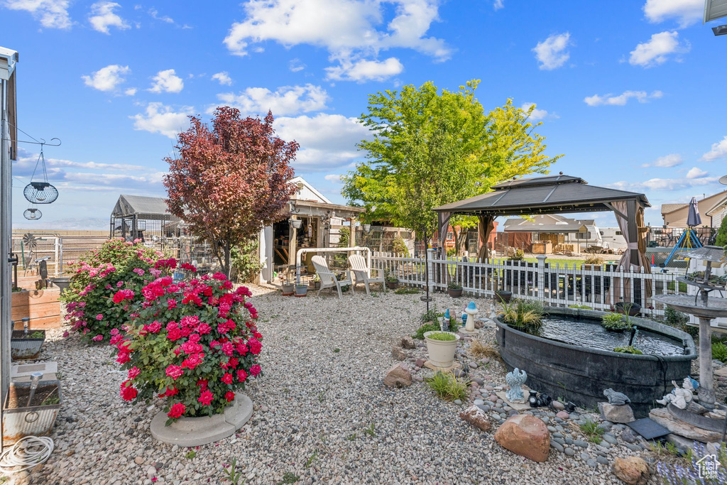 View of yard featuring a gazebo, an exterior structure, and an outbuilding