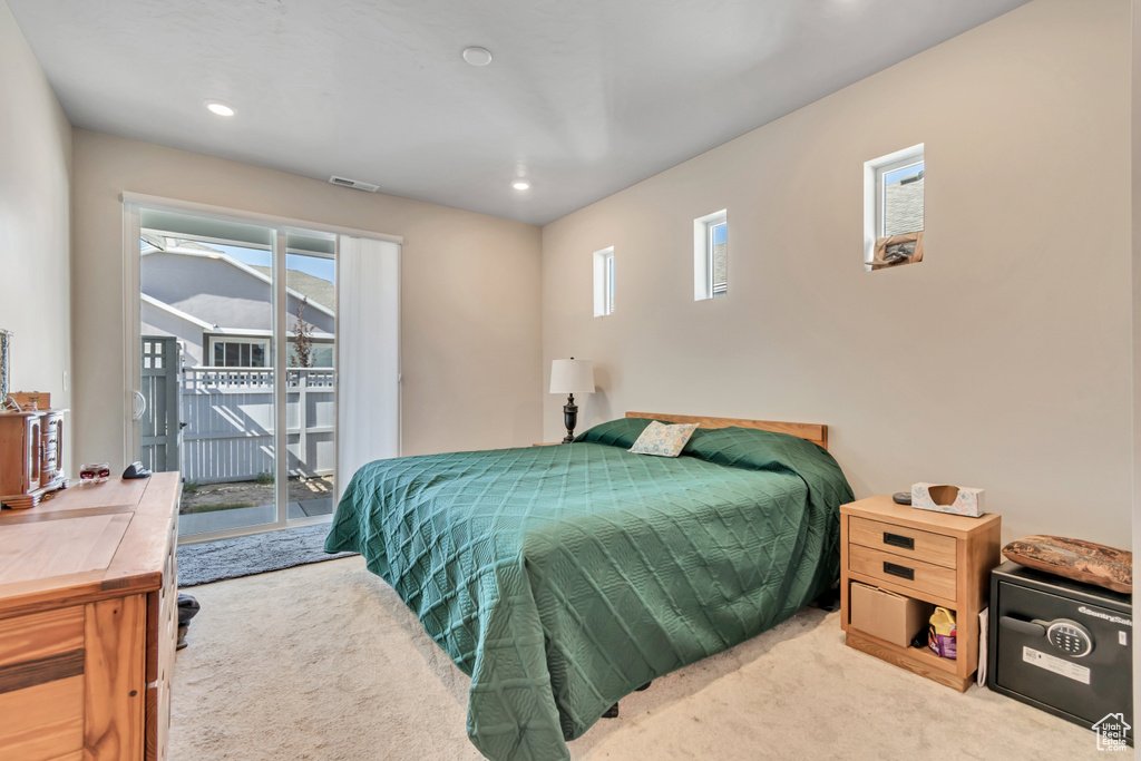 Carpeted bedroom featuring access to outside, multiple windows, and recessed lighting