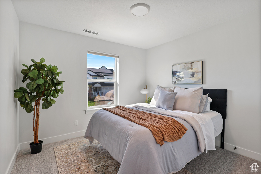 Bedroom with carpet and baseboards