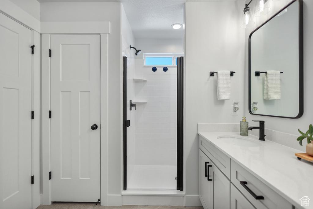 Bathroom with a stall shower and vanity