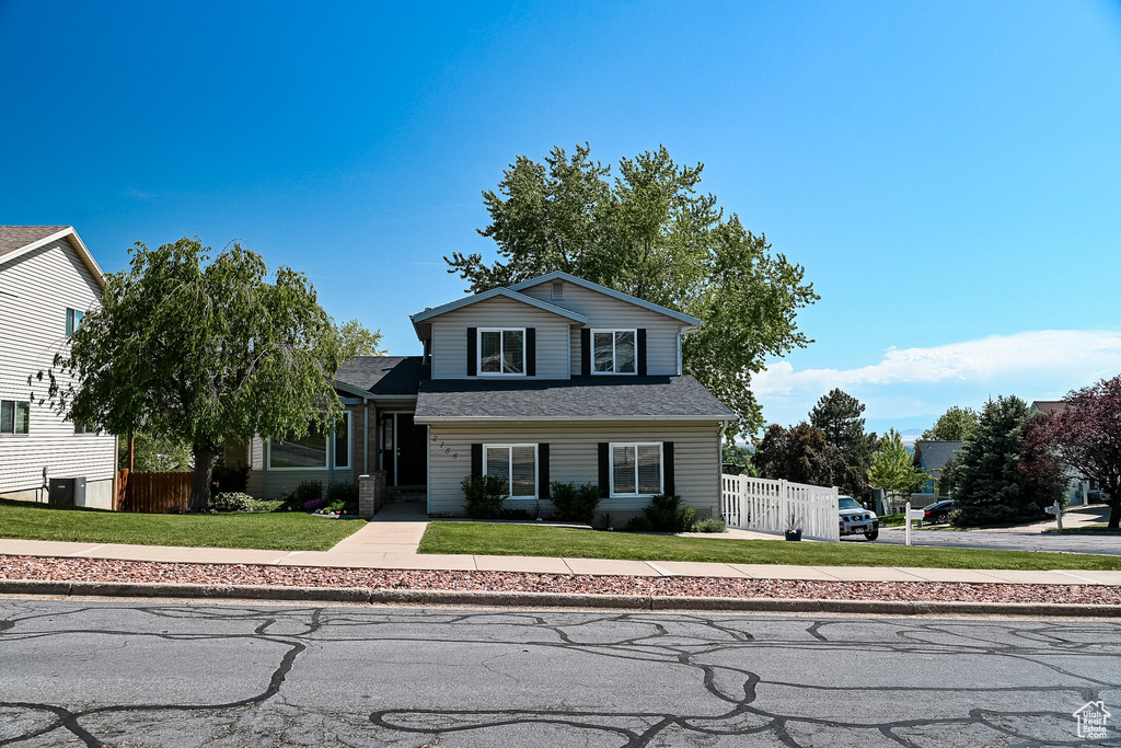 View of front of home with a shingled roof