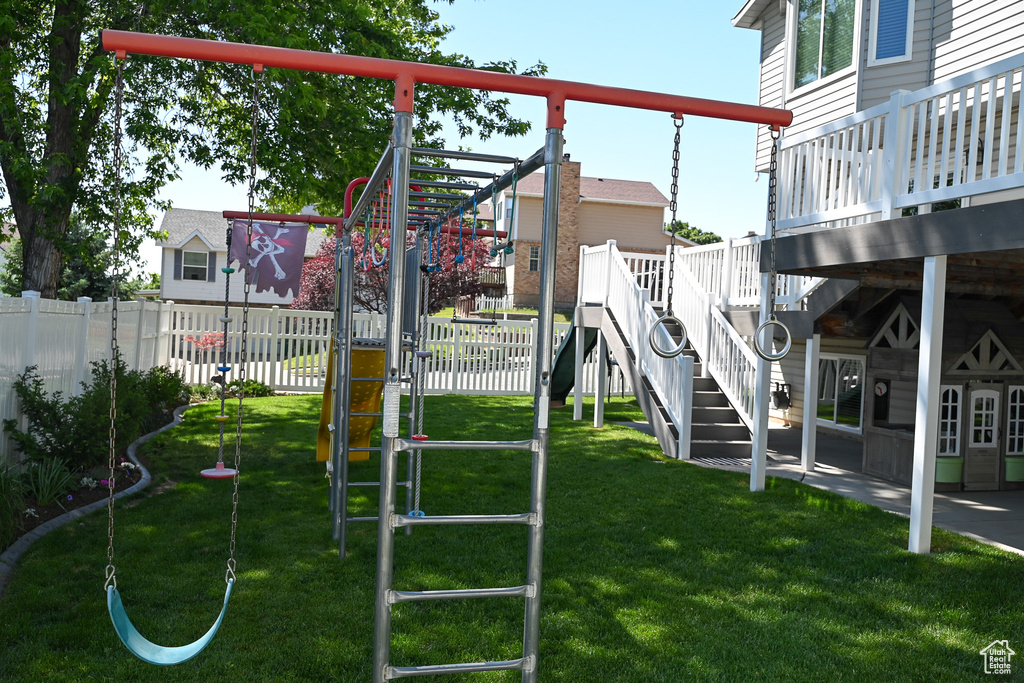 View of jungle gym featuring a wooden deck