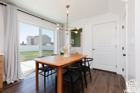 Dining room featuring a chandelier and dark wood-style floors