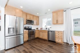 Kitchen featuring light brown cabinetry, appliances with stainless steel finishes, light countertops, and recessed lighting