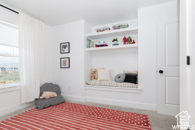 Sitting room with baseboards and carpet floors