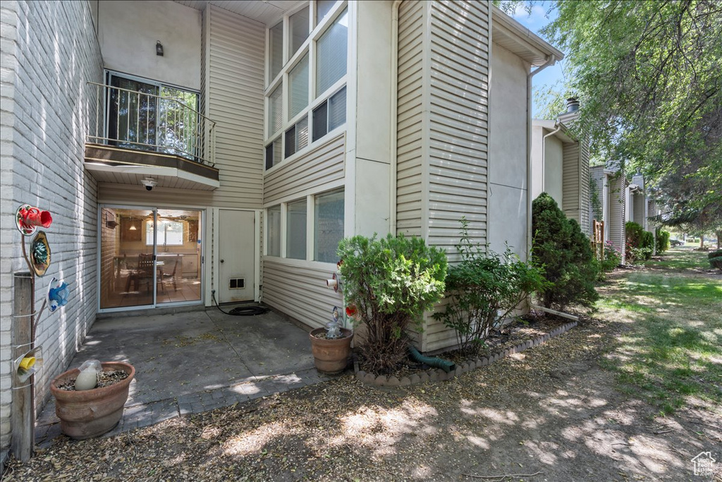 View of exterior entry with a patio