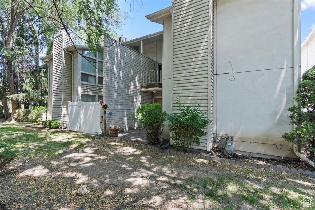 View of property exterior featuring a balcony