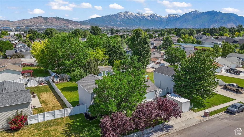 Aerial perspective of suburban area featuring a mountainous background