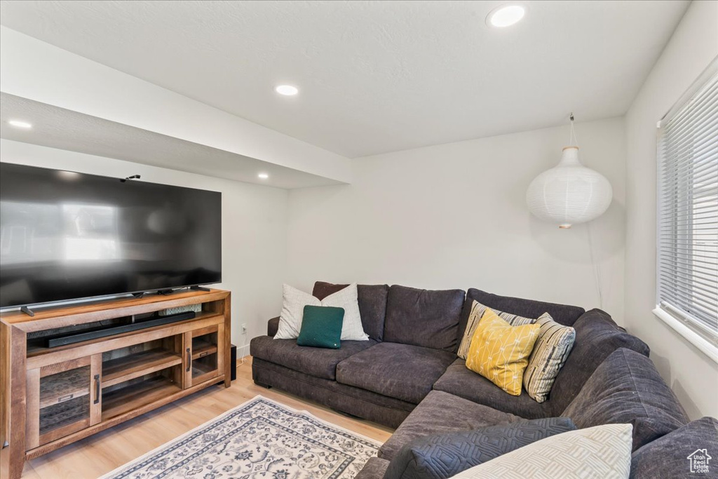 Living area featuring wood finished floors and recessed lighting