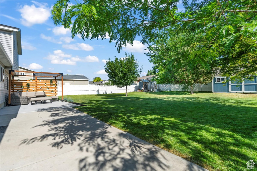 View of yard with a patio area, outdoor lounge area, and an outbuilding