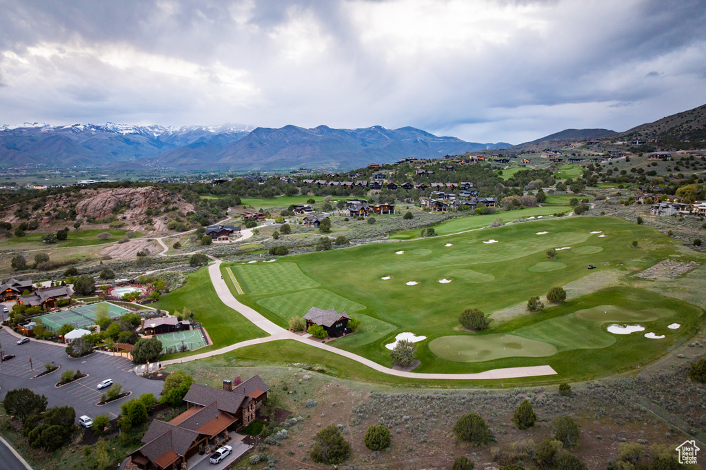 Aerial view of residential area featuring mountains and a golf course