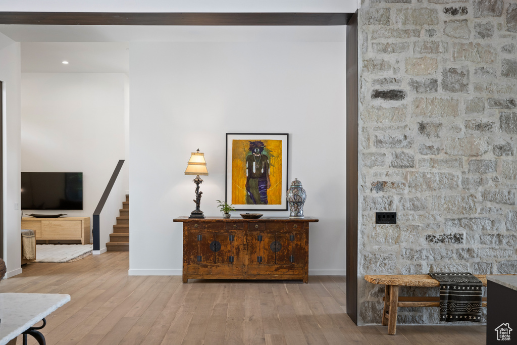 Living area with baseboards, wood finished floors, stairway, and recessed lighting