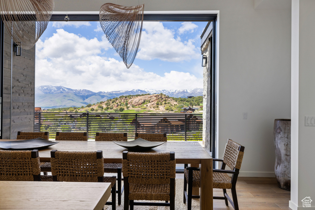 Dining area featuring wood finished floors, a mountain view, and baseboards