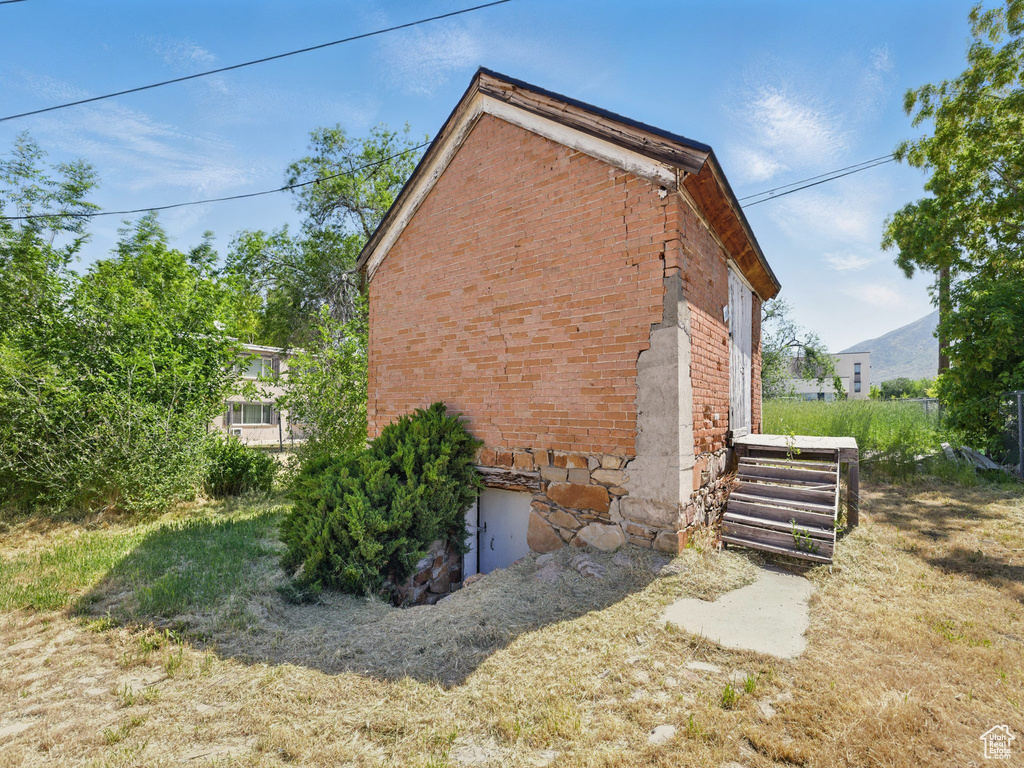 View of side of property featuring brick siding