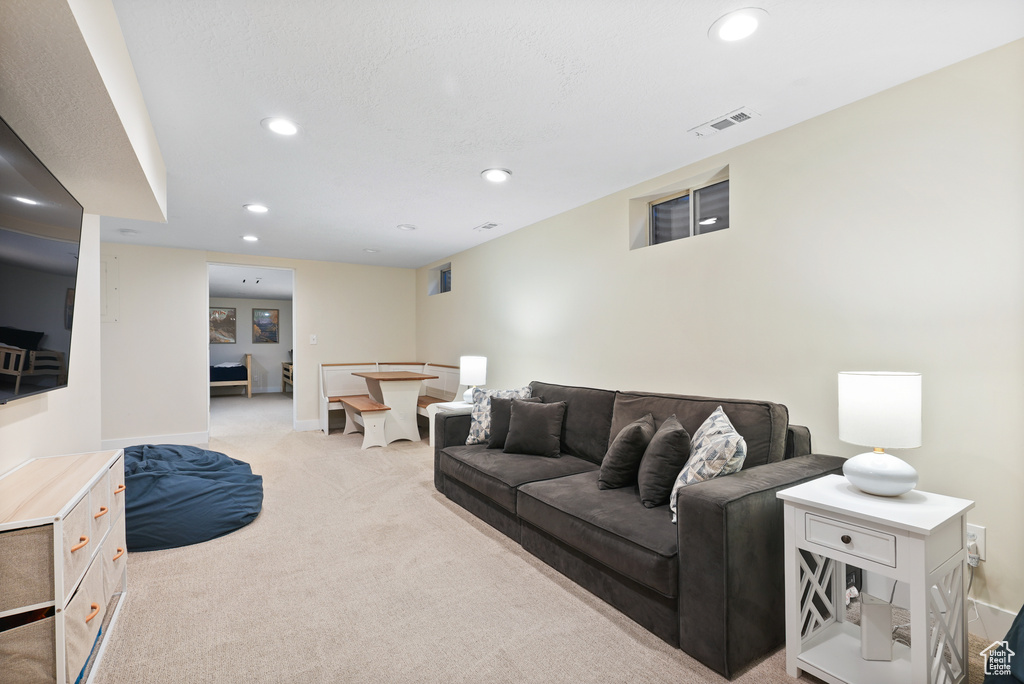 Living room featuring light carpet, recessed lighting, and baseboards