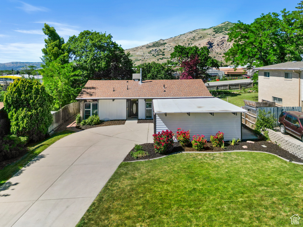 View of front of property featuring a mountain view and concrete driveway