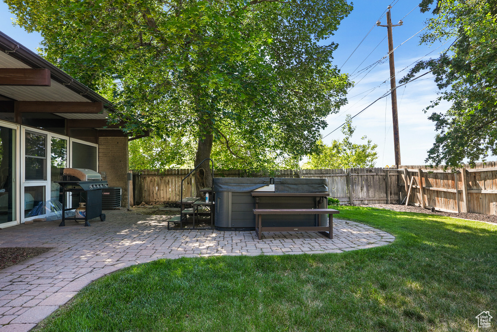 View of yard featuring a patio area and a hot tub