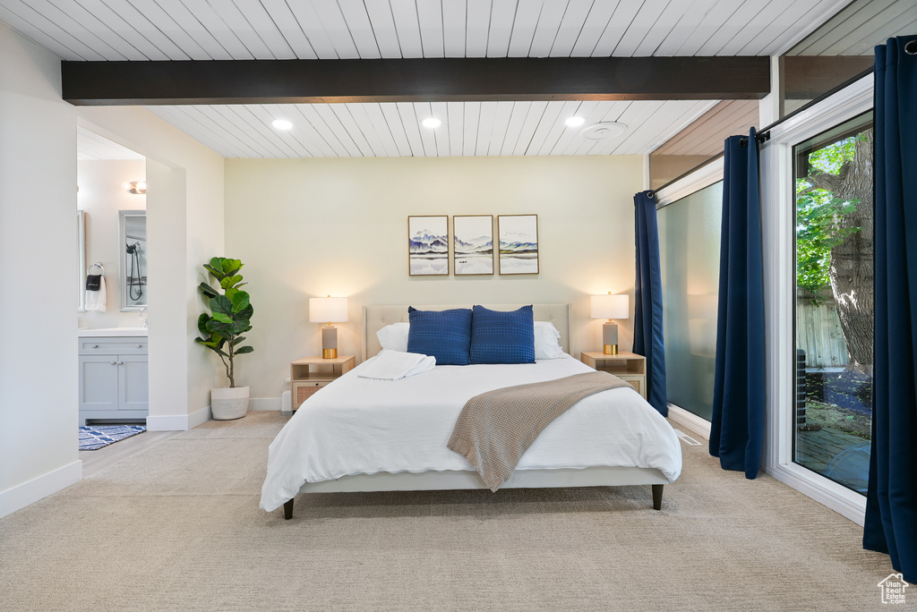 Bedroom with carpet floors, recessed lighting, wood ceiling with exposed beams, connected bathroom, and baseboards