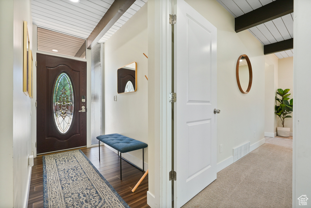 Entryway featuring wood ceiling with exposed beams, baseboards, and recessed lighting