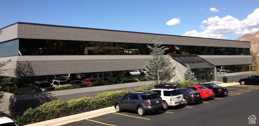 View of building exterior with uncovered parking