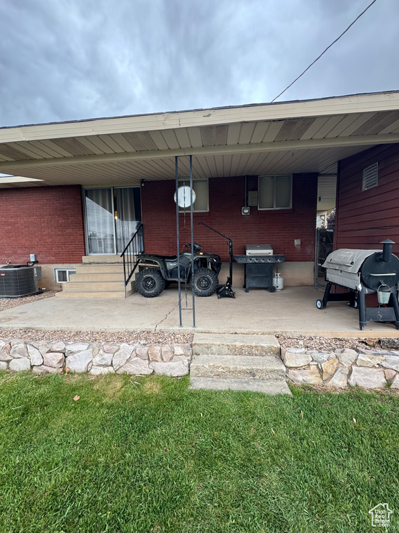 View of car parking with entry steps and an attached carport