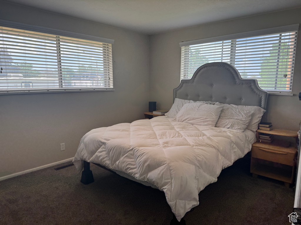 Carpeted bedroom featuring baseboards
